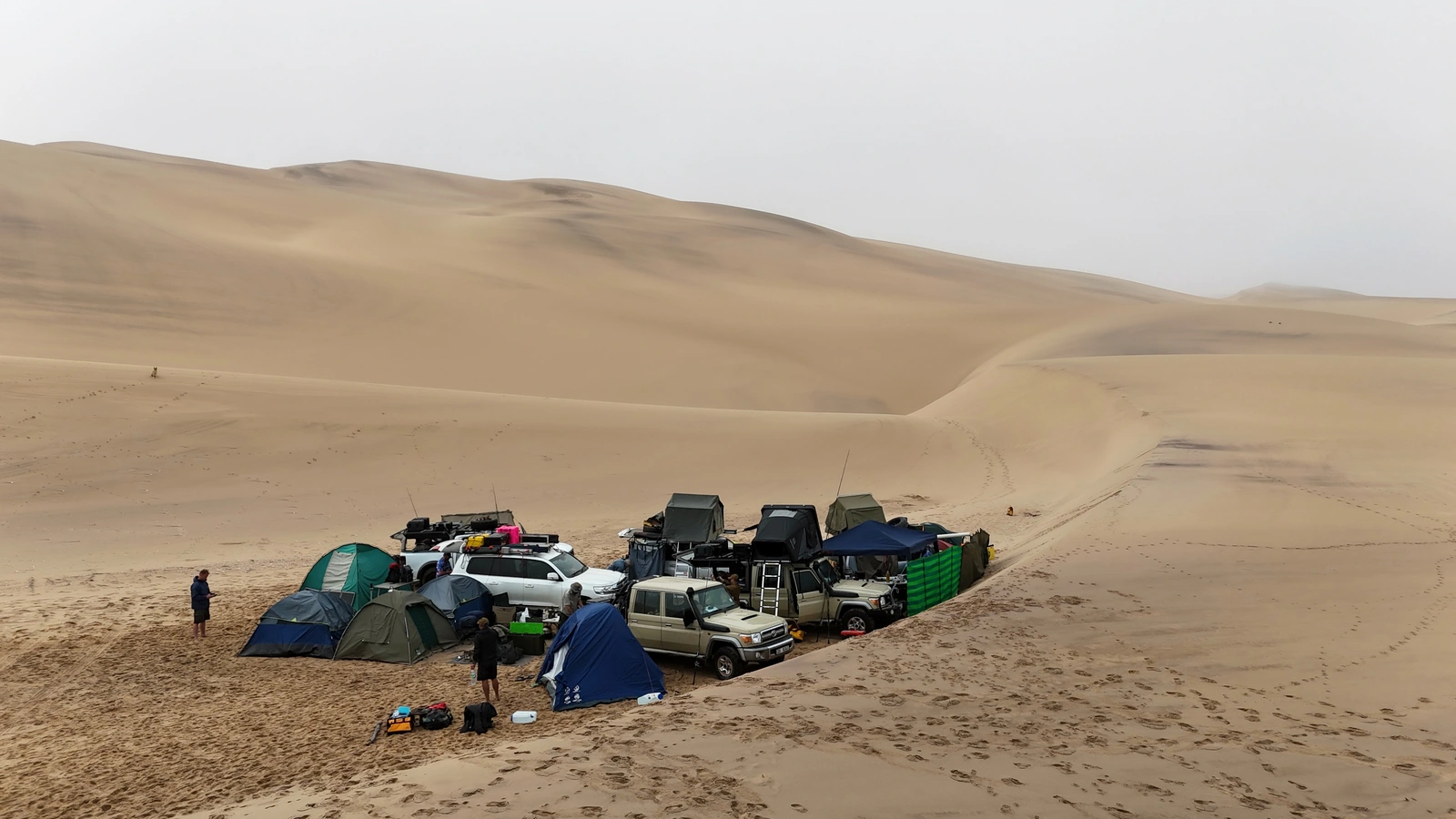 Expedition camp and vehicles among coastal dunes