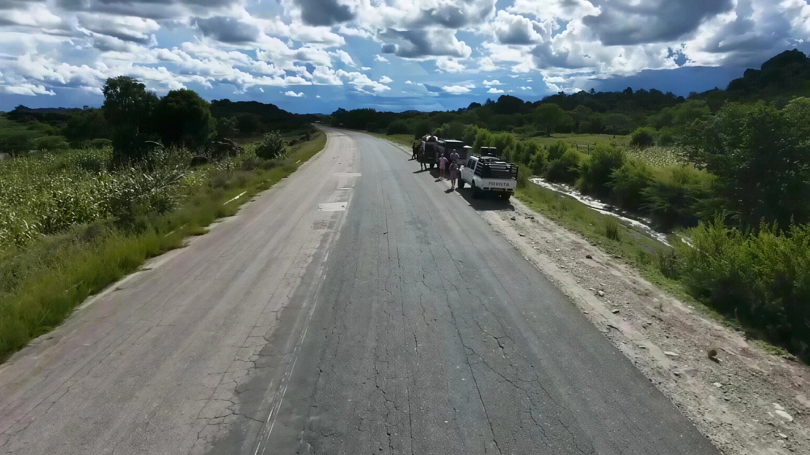Convoy travelling on a road through green hills