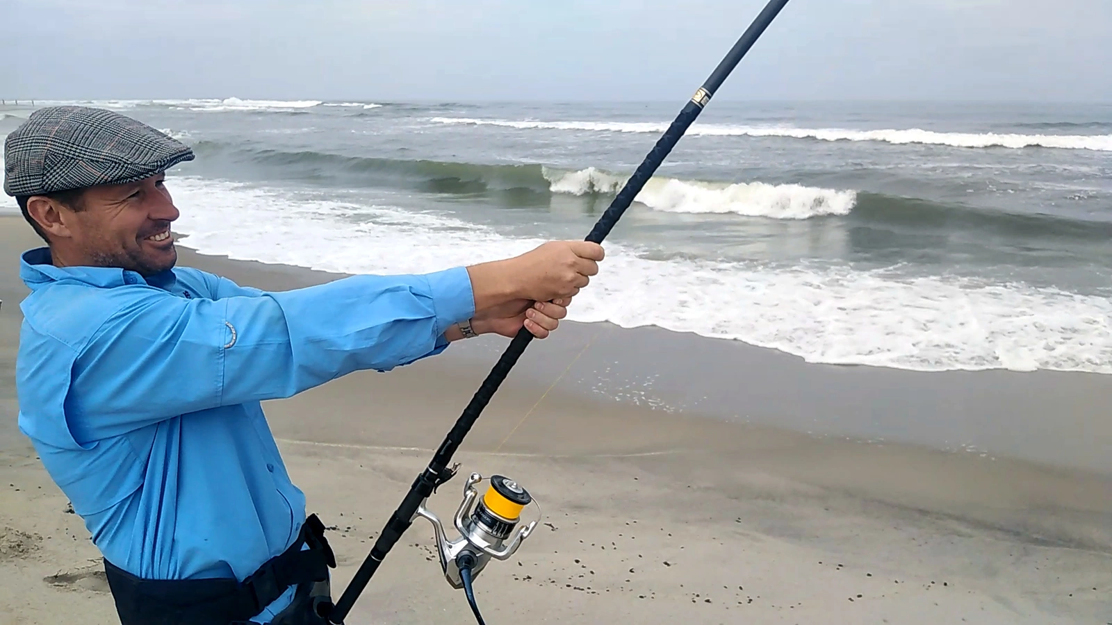 Angler watching the surf with a fishing rod
